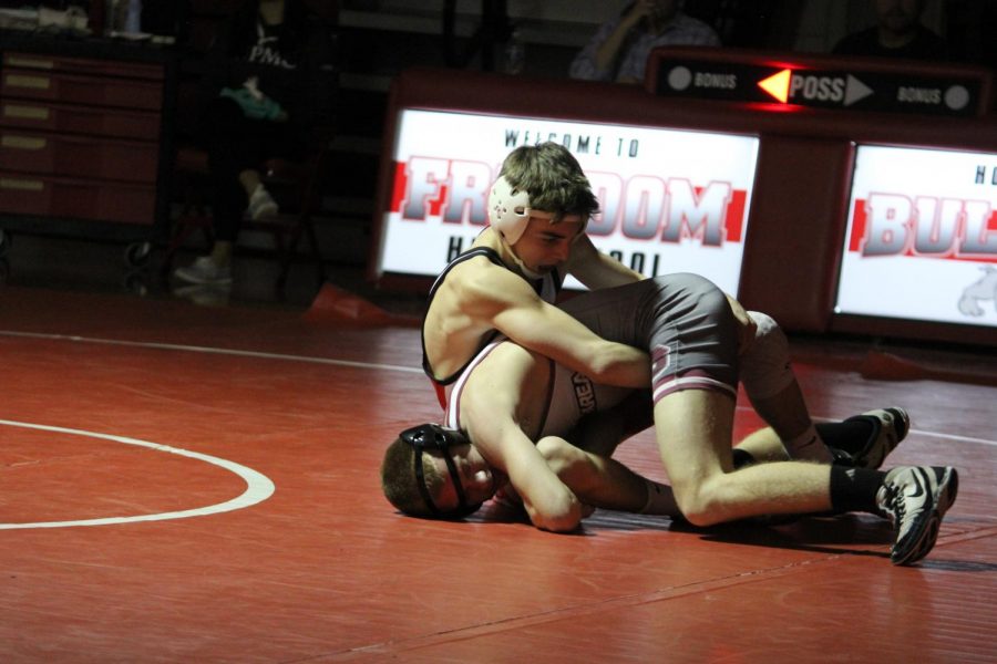 At a home match against Beaver on Jan. 15, freshmen Matthew Schultheis attempts to pin his opponent down while they try to escape the hold.