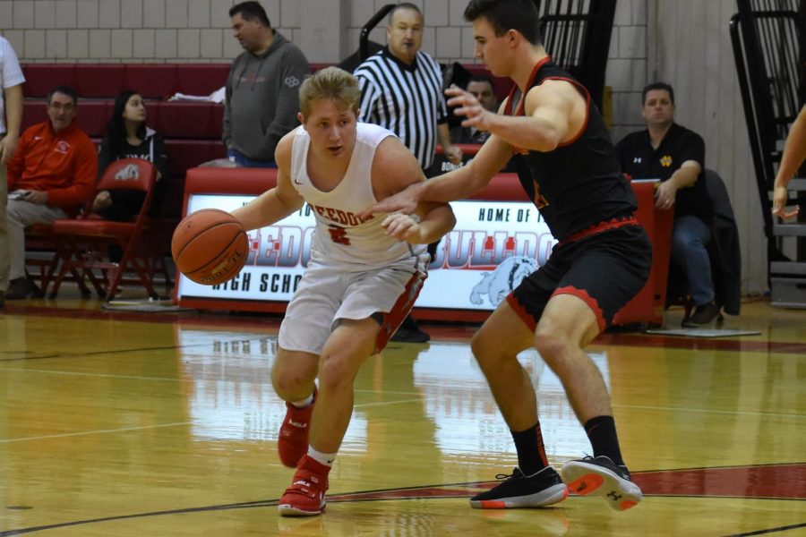 Senior Tyler Borgman looks for his teammates down the court early in the first quarter of the Jan. 17 game against North Catholic.