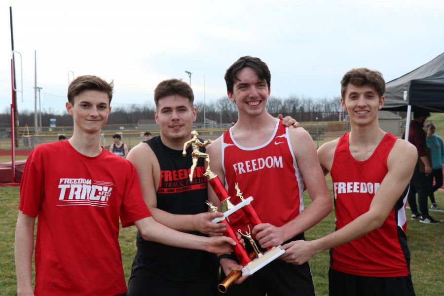  Following the 4x4 relay, the winning team of freshman Colin Fricke, juniors David Matsoff and Garett Paxton and senior Matthew Levenson pose with their trophy, proving their victory.