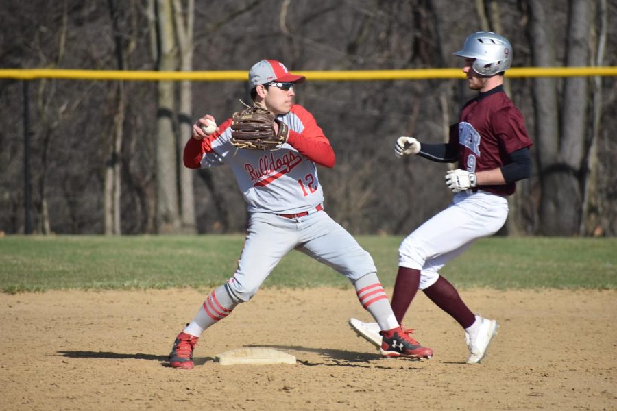 Then-junior Jacob Bauman tags second base before throwing the ball to first base in an attempt to make a double play against Beaver on April 9, 2019.
