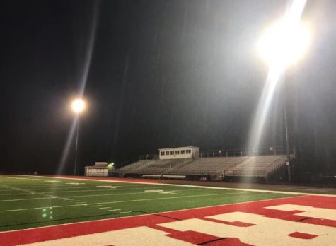 The Bulldog Stadium sits alone under the lights waiting for the upcoming fall sports to begin with players on the field and spectators in the stands.