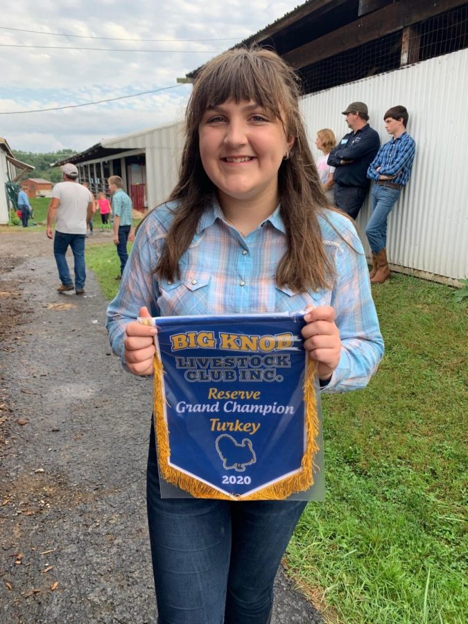 Freshman+Josie+Brenckle+shows+off+the+ribbon+she+won+for+reserve+grand+champion.