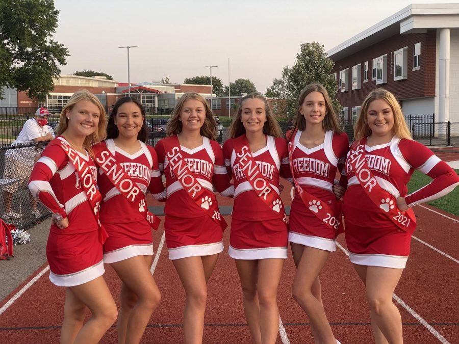 Senior cheerleaders pose for a photo before the marching band performed at Bulldog
Stadium on Sept. 10.