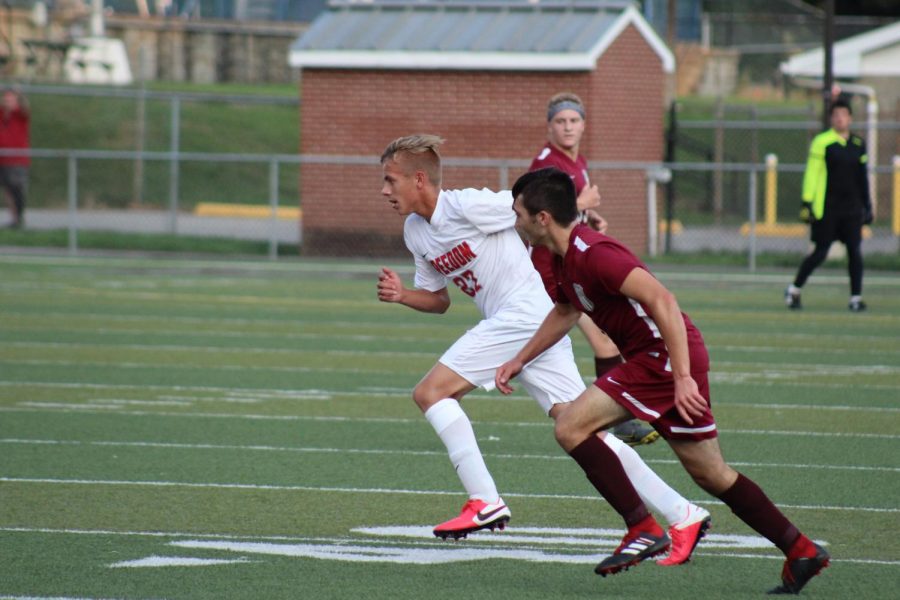 Sophomore Luke Snavely and a Beaver opponent race towards the ball in the Bulldogs'
scrimmage against the Bobcats on Sept. 9.