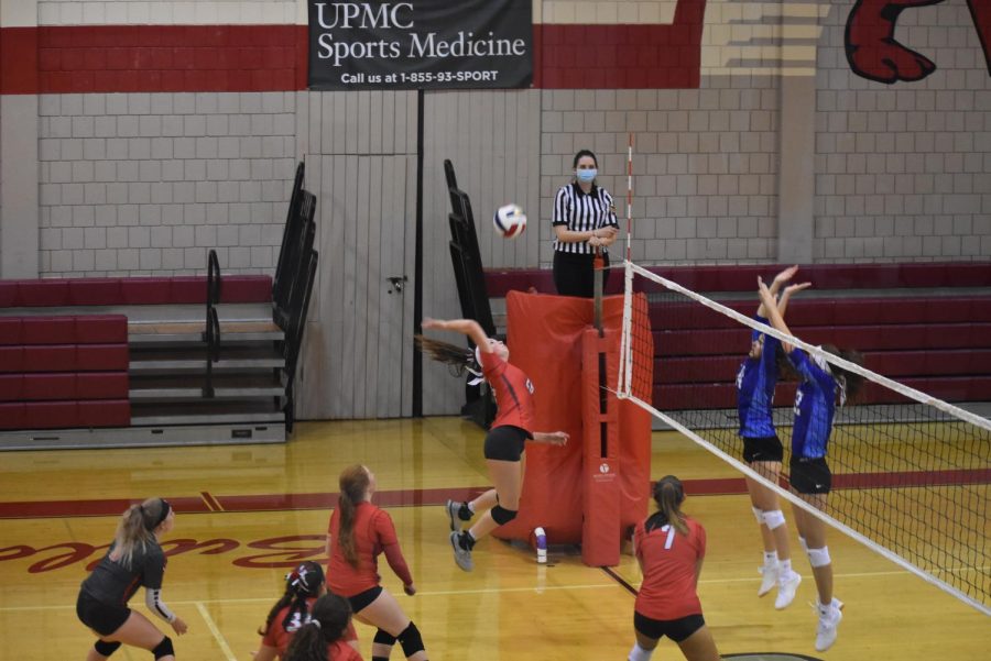 Junior Sara Mengel spikes the ball over opponents from Ellwood City on Sept. 17,
2020.