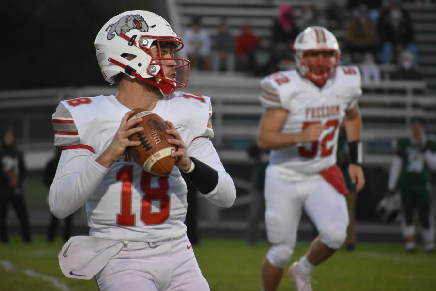 Senior Cole Beck steps back to throw against the Laurel Spartans on Oct. 2.