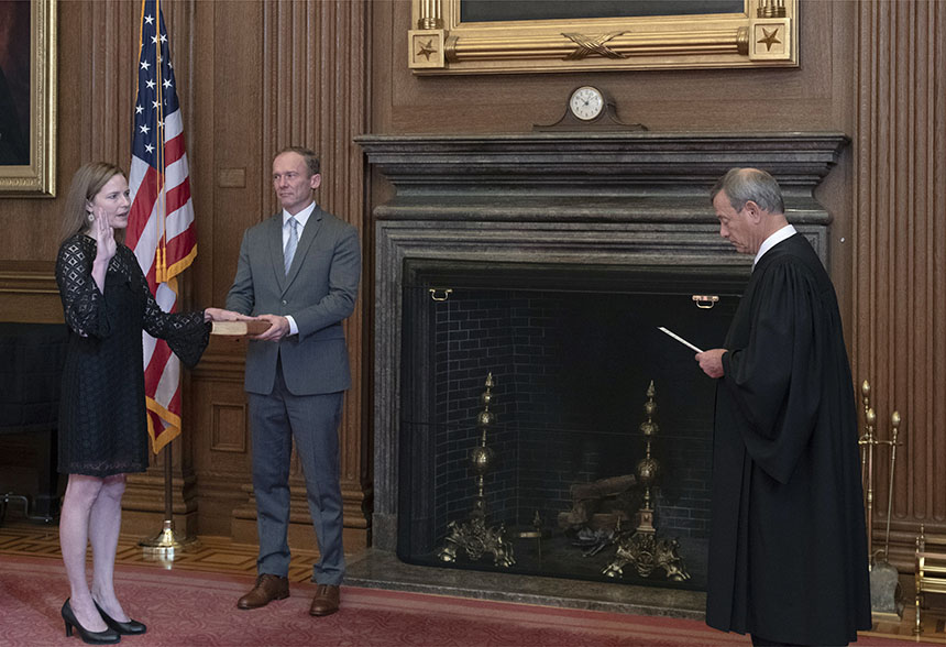 Chief Justice John G. Roberts, Jr., administers the Judicial Oath to Judge Amy Coney Barrett in the East Conference Room, Supreme Court Building. Judge Barrett’s husband, Jesse M. Barrett, holds the Bible.  