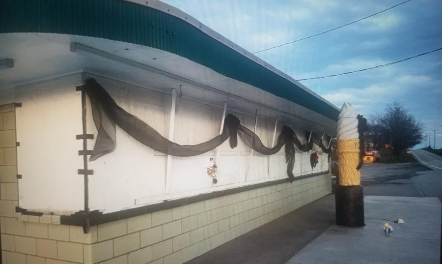 Days after the passing of Paul “Windy” Young, many local supports hung a black ribbon over the front of the custard stand along with flowers and candles to show condolences to the Young family. 