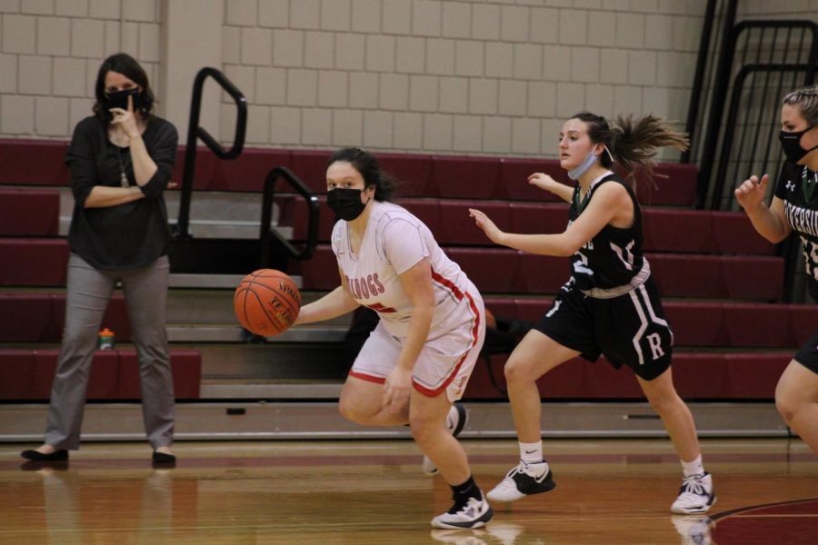 After a defensive steal, junior Grace White looks up the court for an open player on Jan. 26 in a game against the Riverside Panthers.