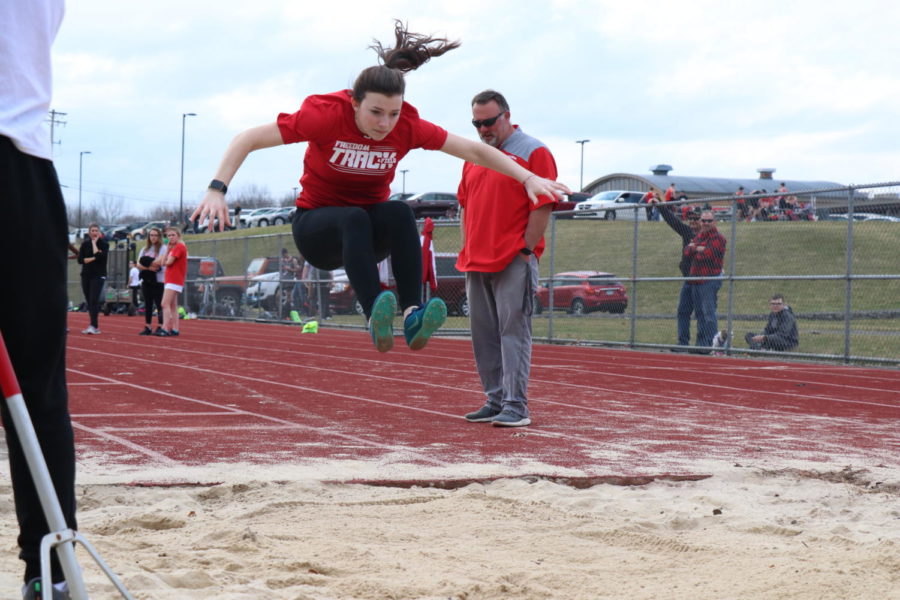Then-sophomore Sara Mengel completes a long jump in a scrimmage at Ambridge on March 12, 2020. The next day, all events would be canceled, marking the end of the team's season before it officially began.