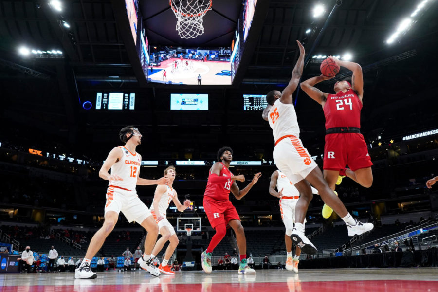 Trying to beat the Clemson defense, Rutgers junior Ron Harper jumps in the air to
attempt a shot, in the First Round of the 2021 NCAA March Madness basketball
tournament on March 19.