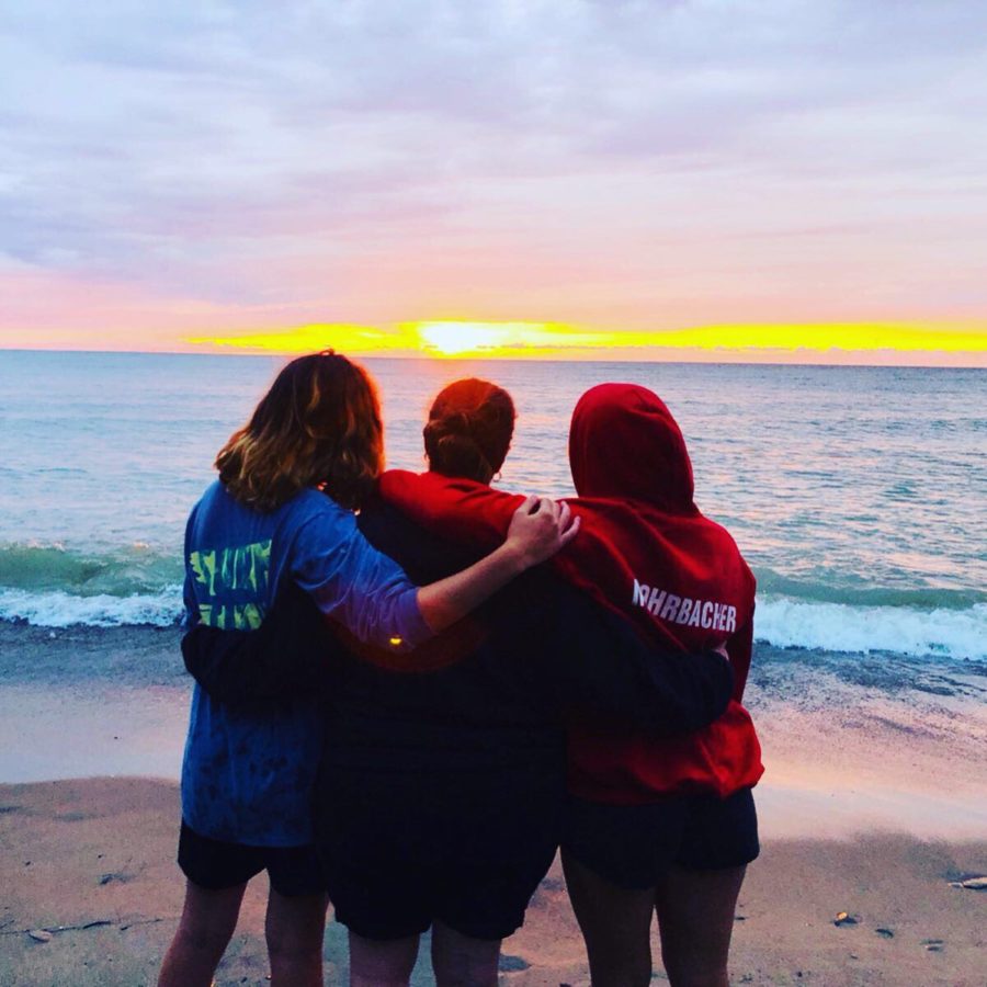 Sophomore Julia (left) and junior Renae Mohrbacher (right) enjoy a sunset on Lake
Erie with their mother, Kristie (center), in August of 2019.