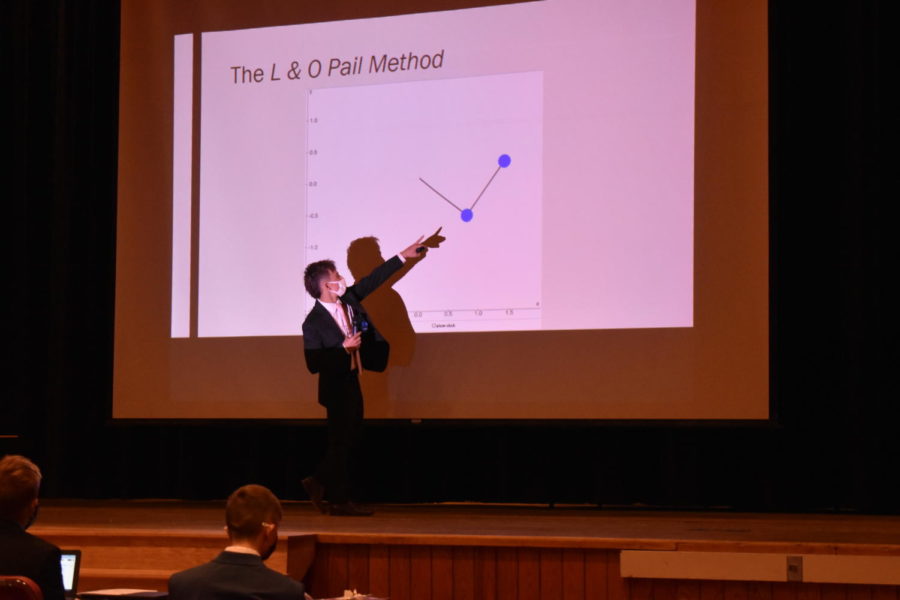 Pointing to the visual on the screen, junior Joshua Pail explains his long-term on complex pendulums.