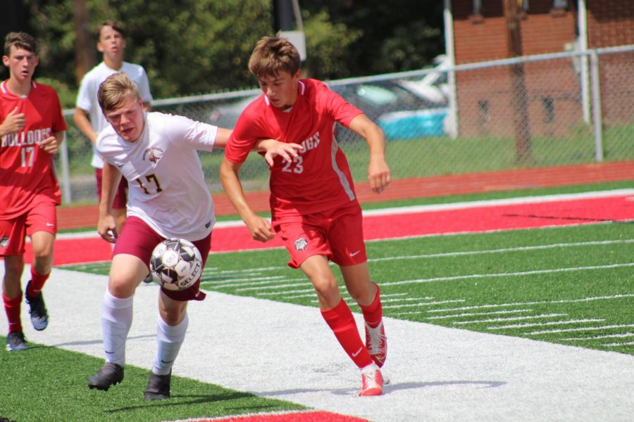 Charging after the ball, junior Austin Tokar tries to advance the ball up the field on Aug. 28 against Chartiers Houston. 