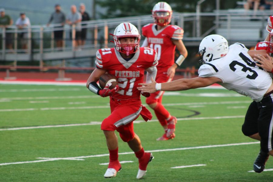 Trying to find the end zone, senior Joshua Pail races the South Side defender to the outside Aug. 27.