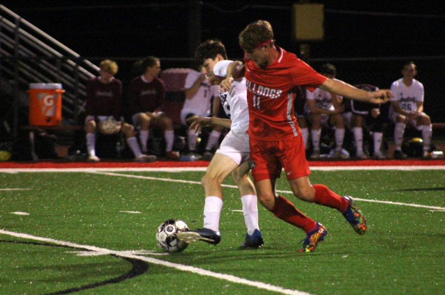 Leaping for the ball, senior Jay Hessler tries to take the ball off of an Ambridge defender on Oct. 5. 