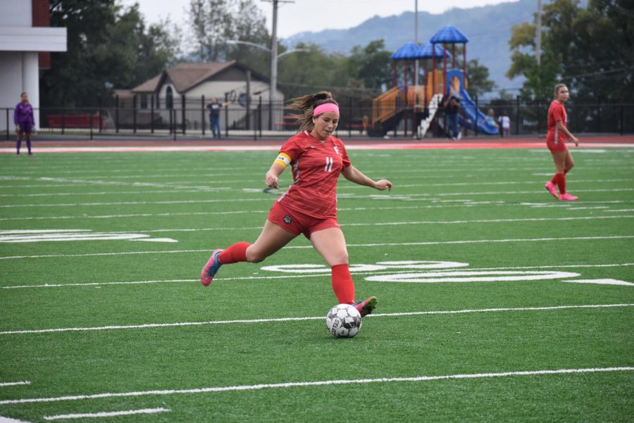 Senior Renae Mohrbacher kicks the ball towards the net on Oct. 14 at their home game against Our Lady of Sacred Heart (OLSH). 