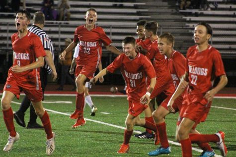 After Couch scores a winning goal against North Catholic, the boys soccer team celebrates their victory on Oct. 7.