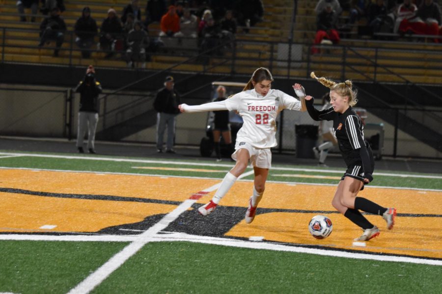 Putting a halt to the Dynamos’ offense, Riley Tokar (9) jumps in front of a Springdale player and kicks the ball out of play, stopping their momentum gain on Nov. 2.