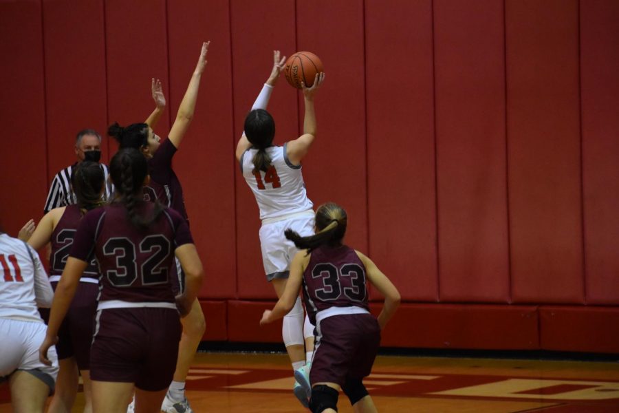 Going for the layup, junior Julia Mohrbacher beats two Beaver defenders at a home
game on Dec. 13.