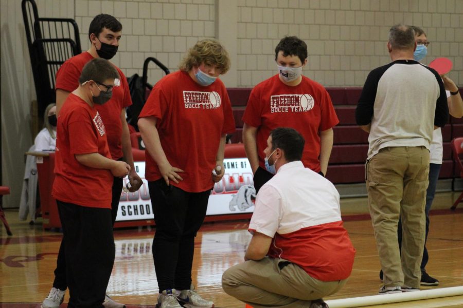 After finishing up their first set on Jan. 19 against Blackhawk, part of the bocce team comes together in a huddle to hear feedback from Coach Mott.