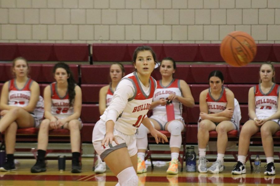 Looking towards her teammates, senior Renae Mohrbacher gets ready to receive the ball during their North Catholic game on Jan. 20.