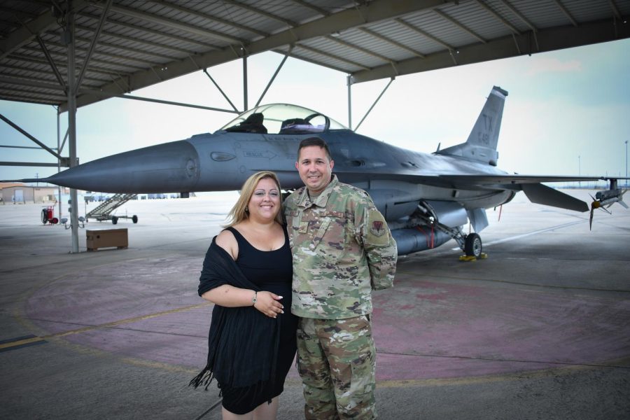 Mr. Kenneth Dickey and his wife stand in front of an F-16 military plane. Dickey served 20 years in the United States Air Force.