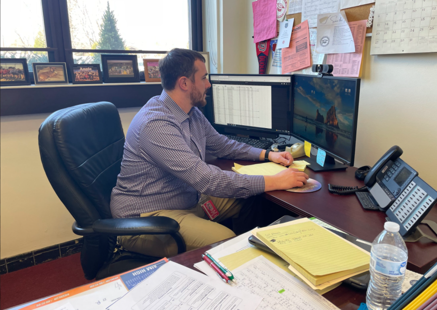 Sitting in his new office, interim principal Mr. Steven Mott looks down at his computer before ending the school day. Mott will be serving as interim principal through the end of this school year.