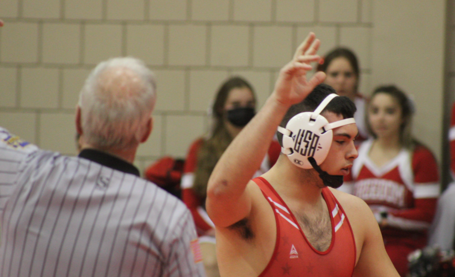 After pinning his opponent from Mars on Jan. 27, senior Landon Millward raises his hand as a sign that he has defeated his opponent.