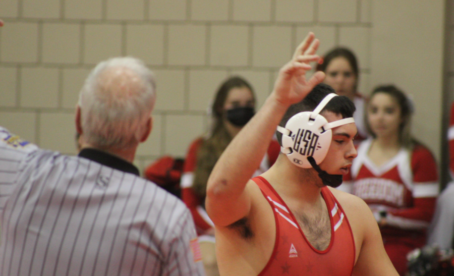 After+pinning+his+opponent+from+Mars+on+Jan.+27%2C+senior+Landon+Millward+raises+his+hand+as+a+sign+that+he+has+defeated+his+opponent.