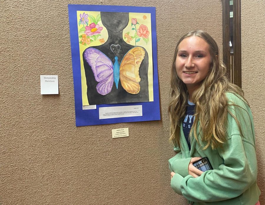 Standing+by+her+artwork%2C+senior+Isabella+Klenk%E2%80%99s+earned+an+honorable+mention+for+her+water+color+painting%2C+%E2%80%9CDeadly+Beautiful%2C%E2%80%9D+during+the+2022+Beaver+County+High+School+Senior+Art+Competition+at+the+Merrick+Art+Gallery+in+New+Brighton%2C+Pa.