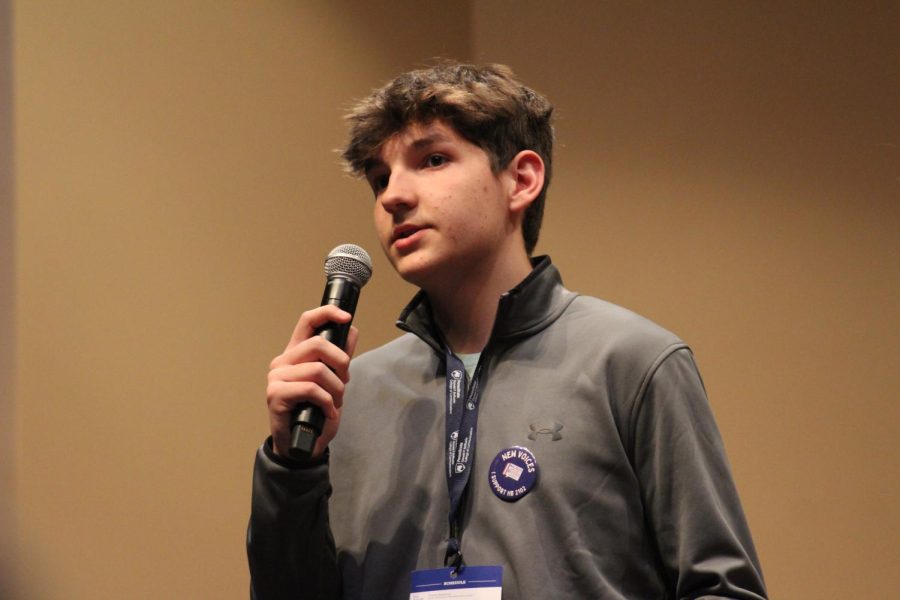 Speaking on stage, freshman Christopher Denkovich talks to the crowd about New Voices legislation.