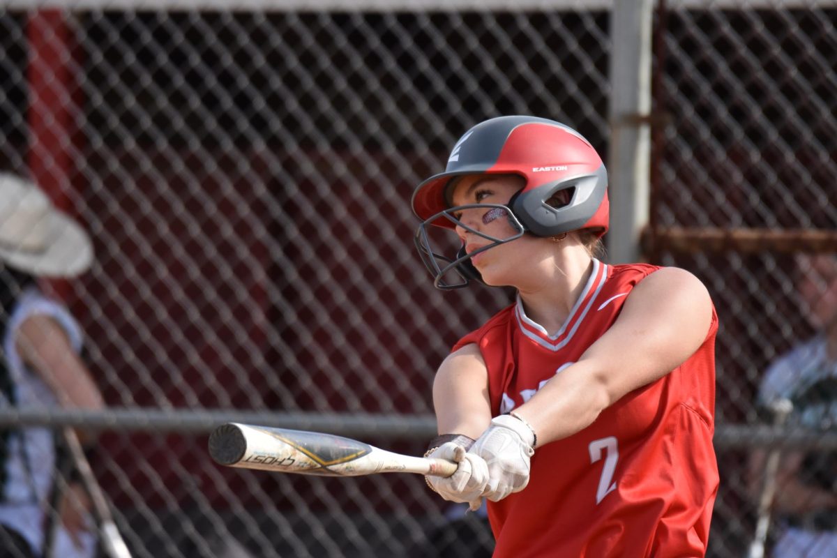 Waiting to get in the batter's box, senior Brandi Bonzo watches the pitcher throw a few warm up pitches.