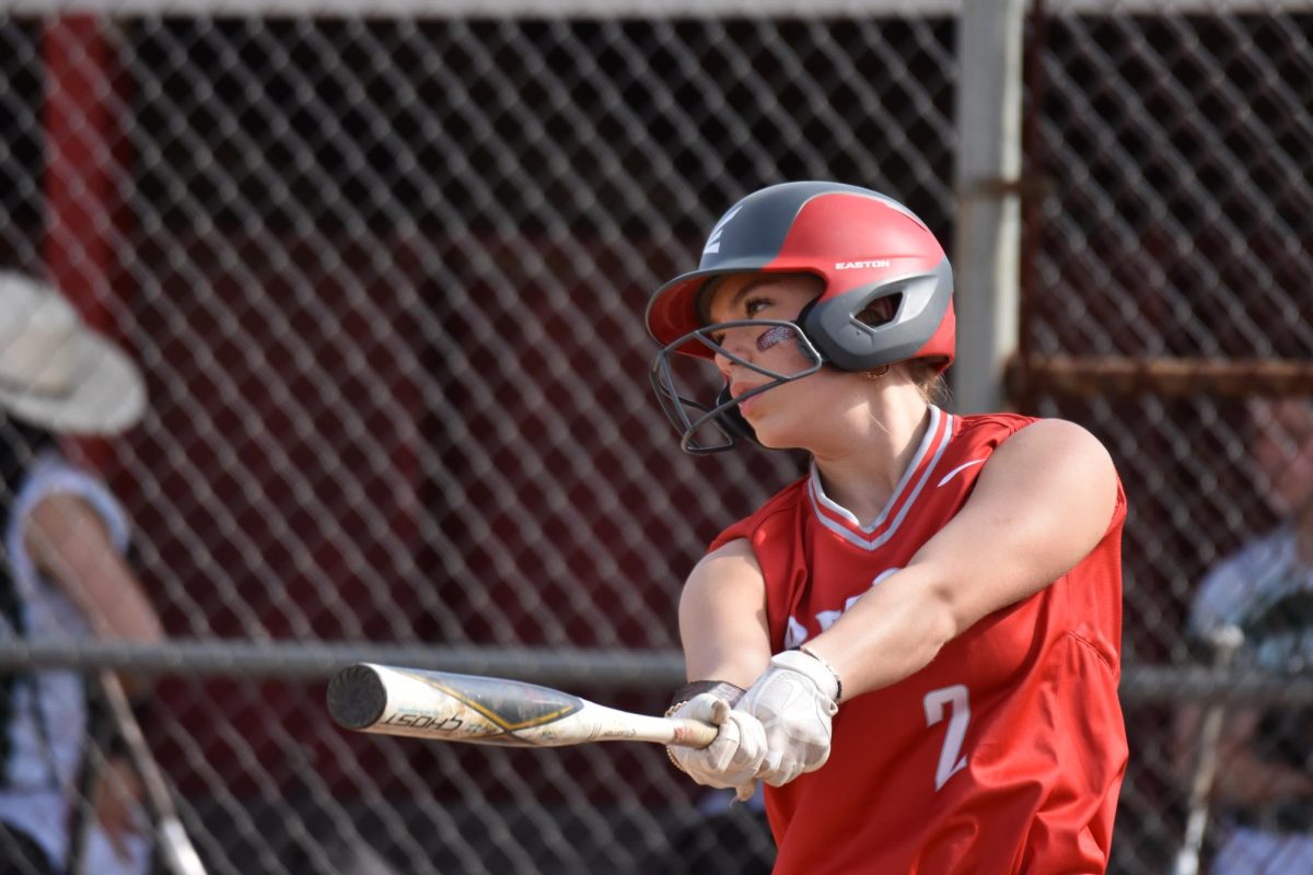 Waiting to get in the batters box, senior Brandi Bonzo watches the pitcher throw a few warm up pitches.