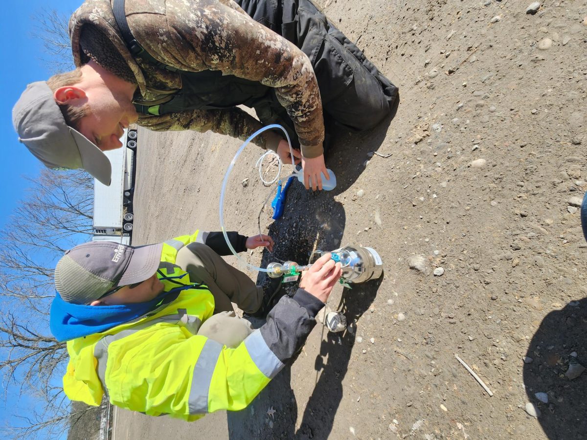 Conducting an inspection, Envirotrac LTD. field scientists Mike Dofner and Jack O'Leary run air quality from underground vapors.