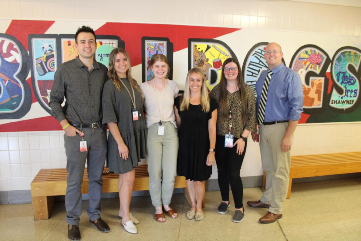 Warm Welcome: The new staff is welcomed to the school by other teachers and students. 
