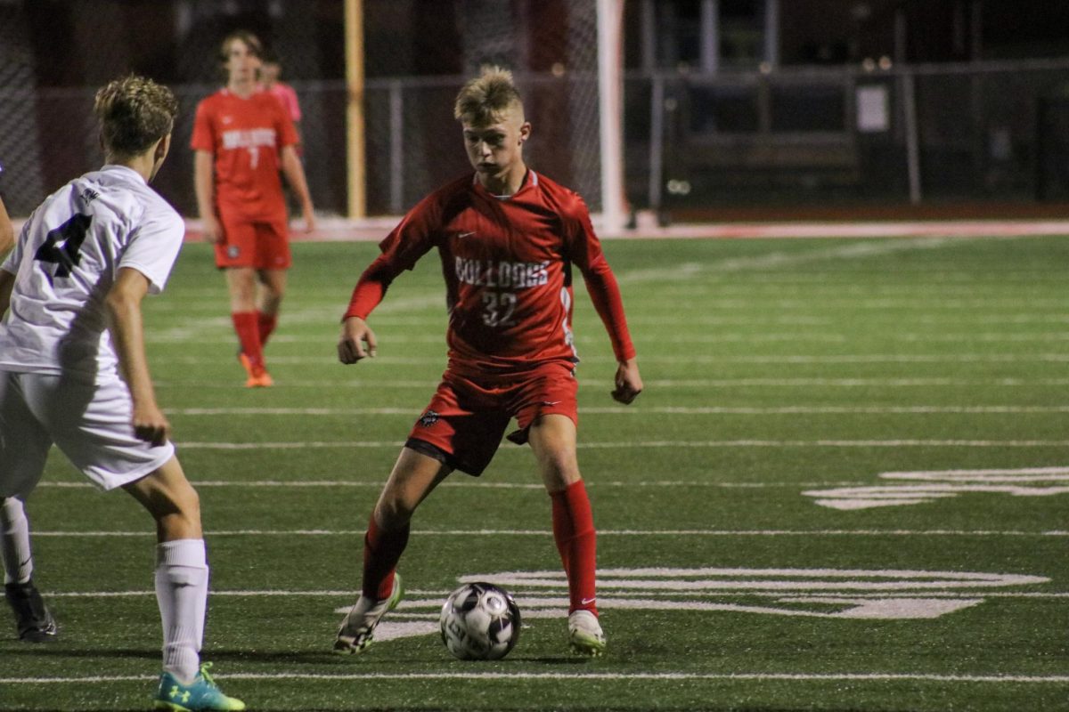 At a home game against Southside on Sep. 14. Junior Jordan Delon is contested against an opponent while trying to deliver the ball to his teammates. A common play when contested with the ball is to pass the ball back to midfield to create space and an opportunity to try again.
