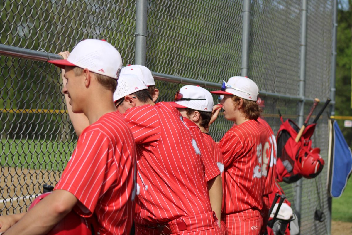 Watching+the+field+intently%2C+members+of+the+baseball+team+cheer+on+the+players+on+the+field.+The+game+took+place+on+Monday%2C+May+8+against+Northgate.