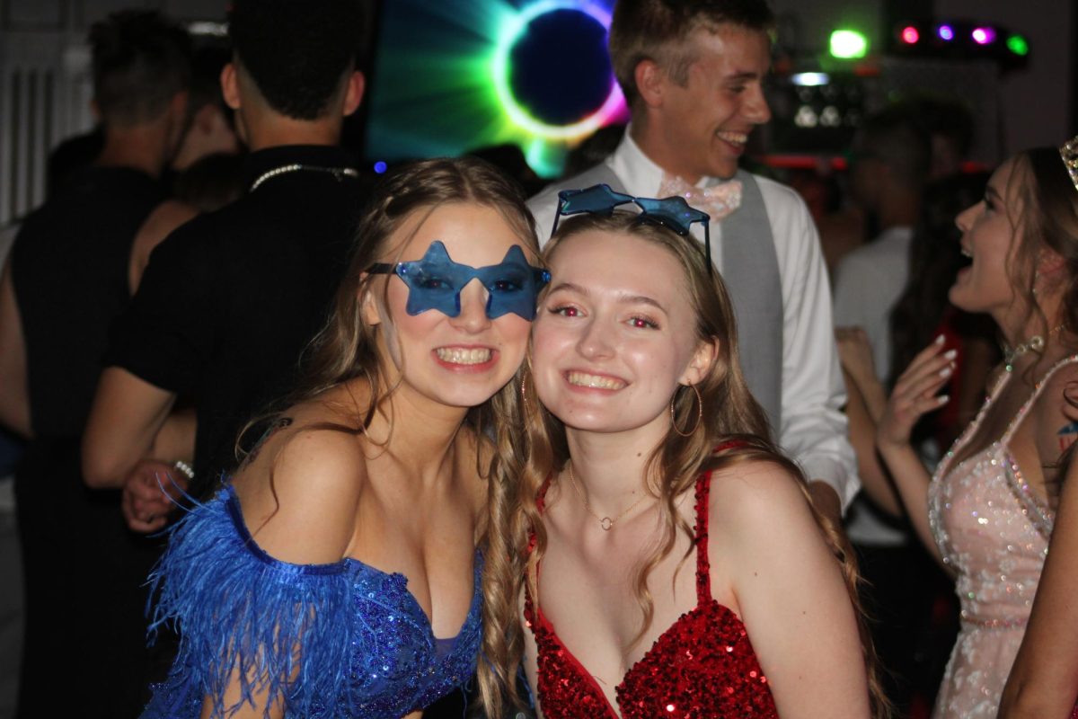 In the midst of dancing, senior Mikalah Smith and junior Alyssa Imhoff stop and pose for a photo.