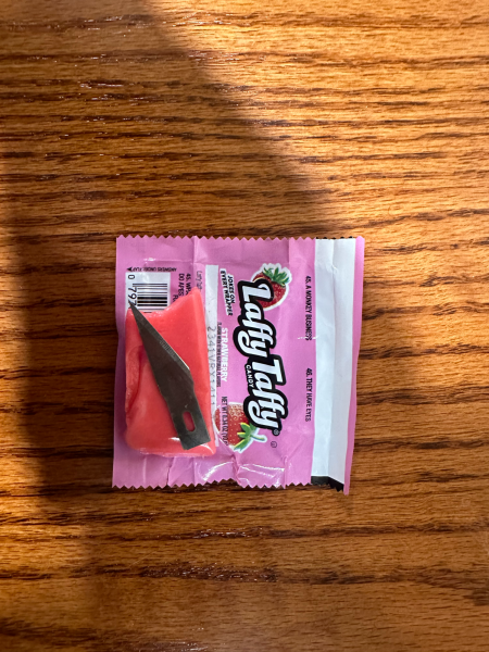 A sharp taste: The packaging of a Laffy Taffy is torn back revealing a razor blade; meant to symbolize how the dangers that come with Halloween could be so easily concealed.