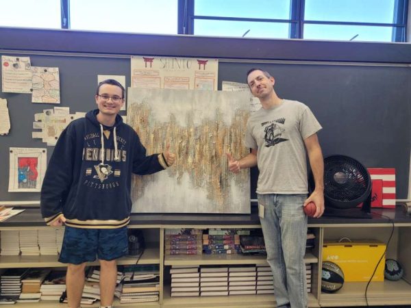 Trash to treasure: Senior Zach Wynn saved a painting from his neighbor’s garbage and gave it as a gift to Mr. Langelli. The painting now resides permanently above Mr. Langelli’s Smartboard, visible to all of his students.
