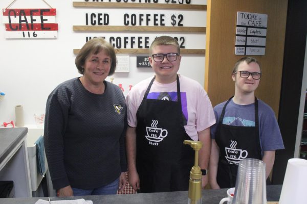 Fresh Beginnings: Smiling at the camera, Ms. Thomas, Steffan Paganie, and Cayden Signorelli stand in the cafe on opening day.
