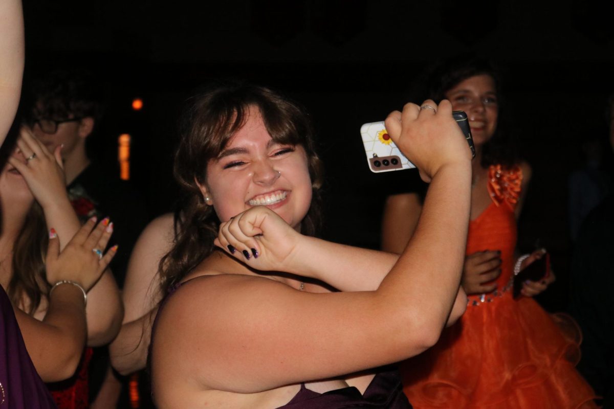 Dancing the night away: At the annual 2023 Homecoming dance, sophomore Elizabeth Smith dances with vigor among her peers. The dance, held in the gym on Sept. 30, features a wide variety of songs to dance to. 