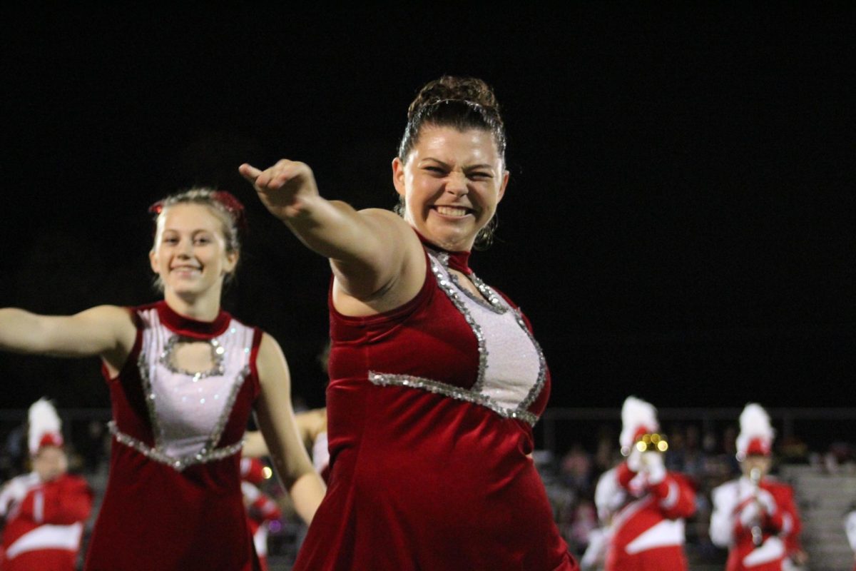 Final hit: Smiling hard, senior Lilly Burguess dances to "Bye Bye Bye" by the band *NSYNC. This halftime performance, on Oct. 27, was the last for Burguess, and the last for the 2023 season.