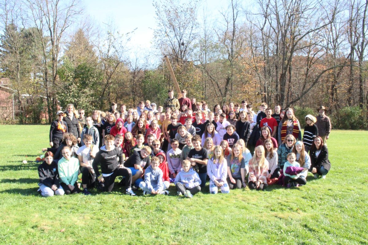 Final Festivities: After the students raced their pumpkin cars and watched the trebuchet launch various items, students posed together for a group picture. The Fall Fest allows the high school Physics Club to get younger students interested in science.