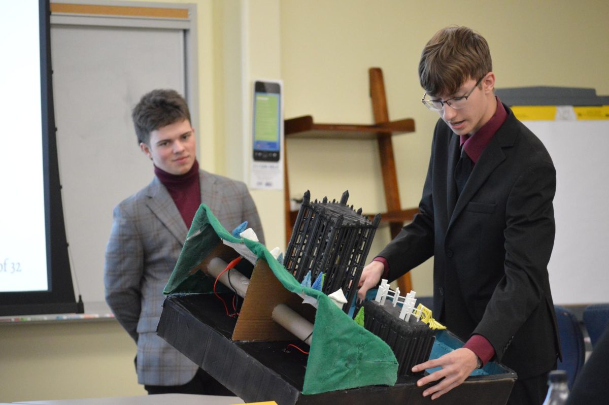 Showing Off: Presenting their model, Senior Logan Larrick presented the teams physical diagram at the regional Powering Pittsburgh competition, where they later won.
