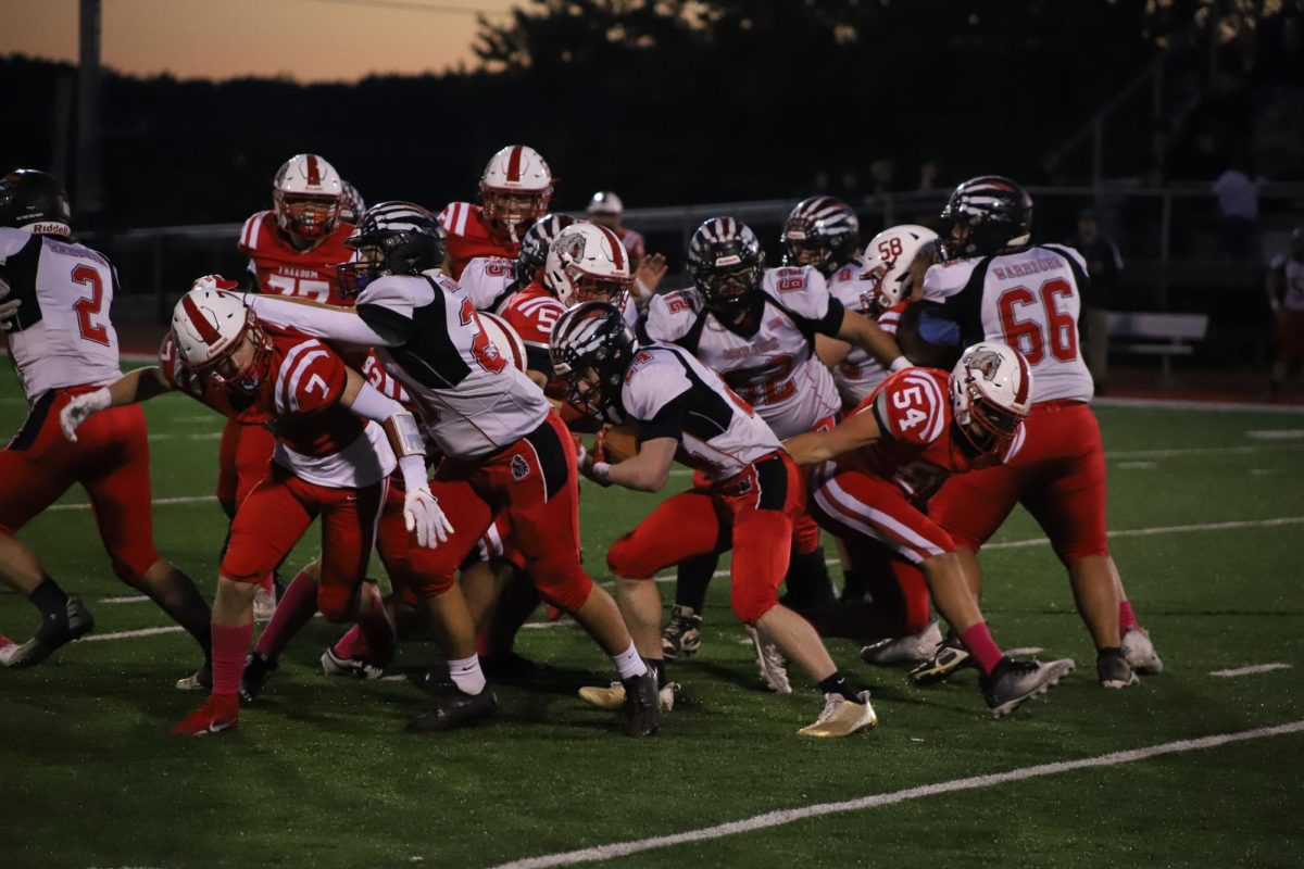 Breaking through: Pushing the offense, the Bulldog defense attempts to down the Mohawk runner. As the blockers are cleared out, the defense files through to complete the tackle.