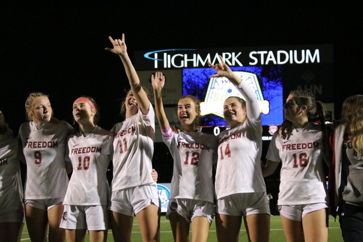 Group+celebration%3A+Looking+up+to+the+crowd%2C+the+girls+soccer+team+signs+I+love+you+to+Farrisa+Roberts+mom.+The+girls+faced+off+RIverview+at+Highmark+Stadium%2C+ultimately+winning+with+a+close+score+of+1-0.