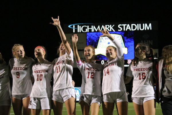 Group celebration: Looking up to the crowd, the girls soccer team signs I love you to Farrisa Roberts mom. The girls faced off RIverview at Highmark Stadium, ultimately winning with a close score of 1-0.