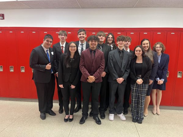 Winding down: DECA students pose for a group photo after returing from the DECA regional competition on Dec. 6. After meeting every Tuesday, the students were finally able to showcase their abilities.